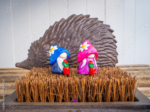 Wallpaper Mural Couple Gnomes with Flower Pots in front of a Metal Hedgehog in the Garden Torontodigital.ca