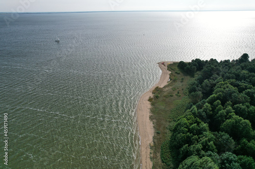Obraz na płótnie Aerial view with dunes, forest, sea and sail boat in Curonian spit on a sunny day photographed with a drone