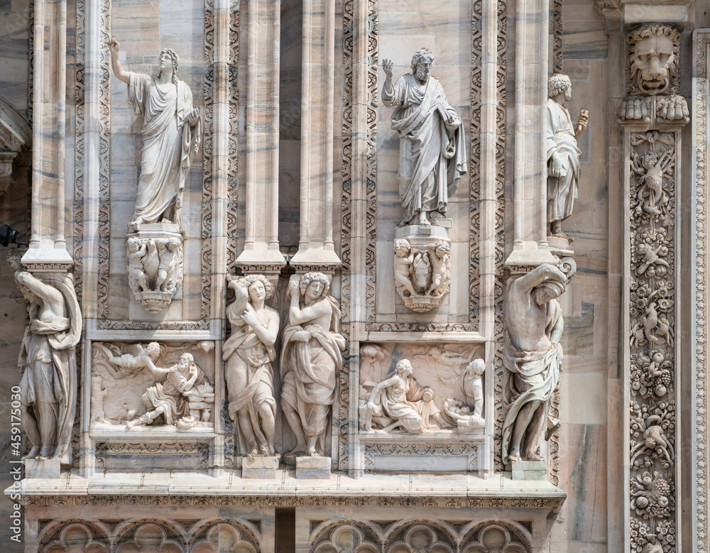 Fototapeta premium marble statues on the facade of the cathedral, Duomo in Milan, Italy