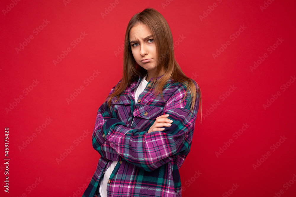 Photo of sad offended touchy young charming nice pretty dark blonde woman with sincere emotions wearing hipster purple check shirt isolated over red background with free space Photo of sad offended touchy young charming nice pretty dark blonde woman with sincere emotions wearing hipster purple check shirt isolated over red background with free space