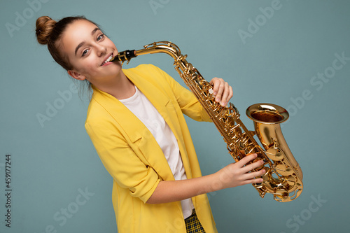 Canvas Print Photo shot of beautiful happy smiling brunette little girl wearing stylish yello