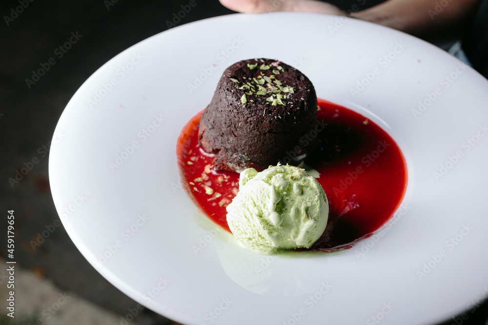 cream with chocolate fondant and strawberry sauce cream with chocolate fondant and strawberry sauce