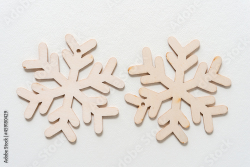 wooden snowflake on a light background © eugen