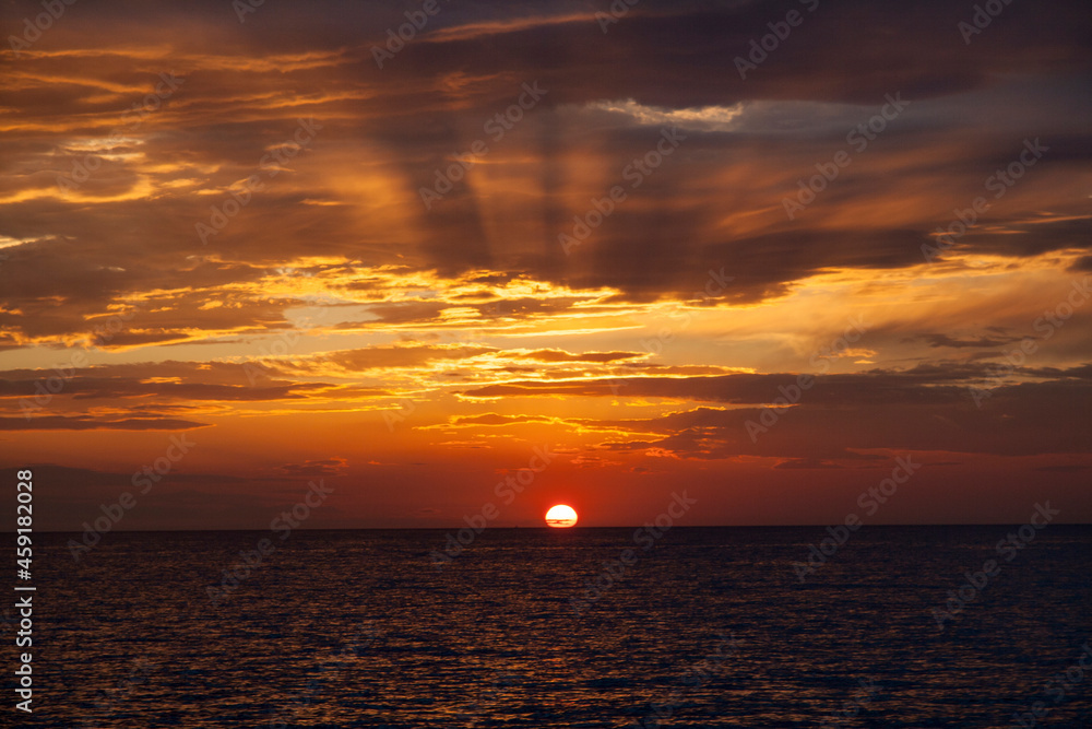 sunset in the sea with sunrays