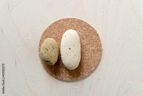 Canvas Print two brick stones on a cork coaster on a wooden background