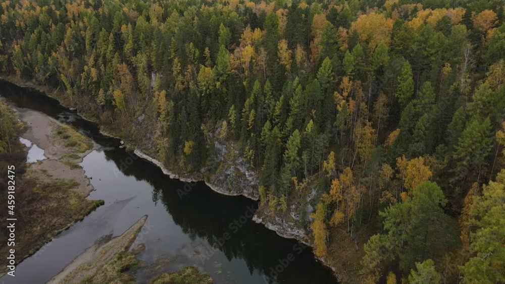 River and forest in autumn filmed from a drone