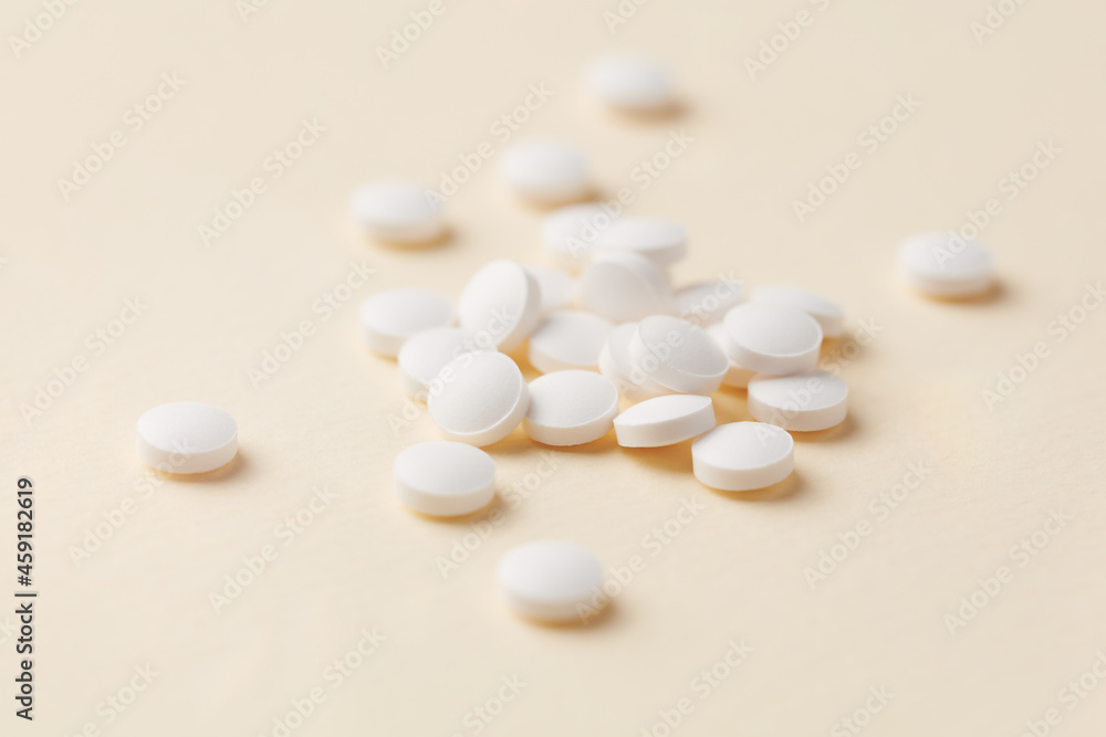 Biotin Tablets. Bright paper background. Close up. Biotin Tablets. Bright paper background. Close up.