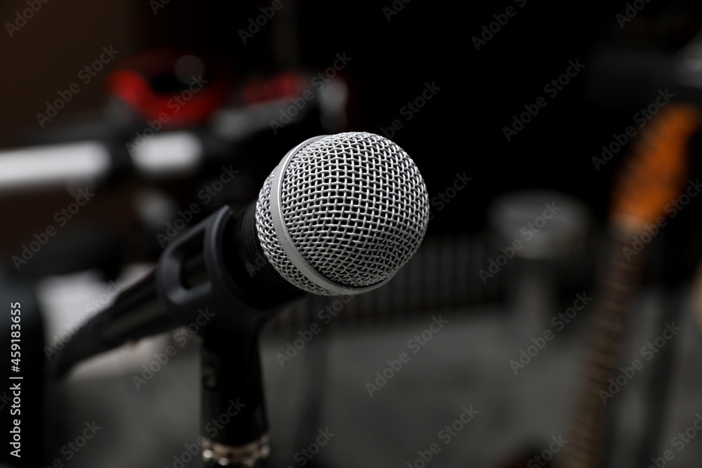 Modern microphone at recording studio, closeup with space for text. Music band practice Modern microphone at recording studio, closeup with space for text. Music band practice