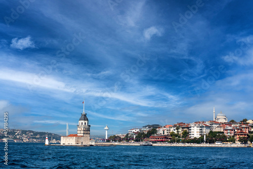 The Maiden Tower in Istanbul, Turkey on a clear day, with Bosphorus Bridge in background.