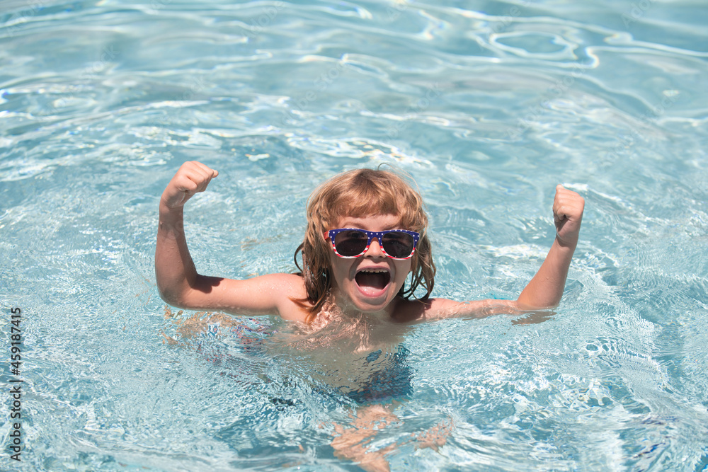 Child in summer swimming pool. Excited cute little boy in sunglasses in pool in sunny day.