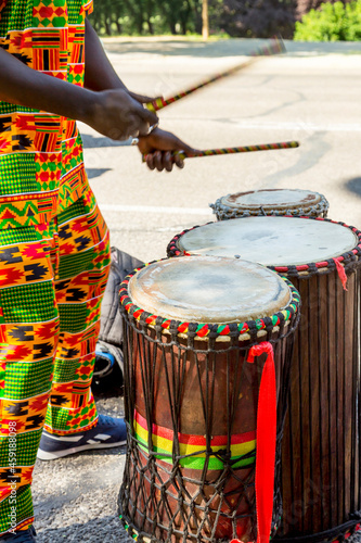 Senegalese man, playing African drums.