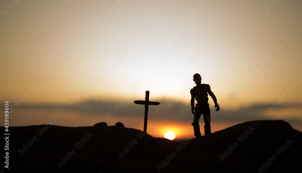 Fototapeta premium Silhouette some zombies on the cemetery walking around at sunset. Selective focus