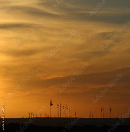 Windmills in the distance during sunset in West Texas. 