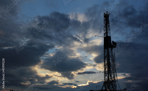 Very nice scenary in West Texas during sunset with an oil rig and clouds in the background