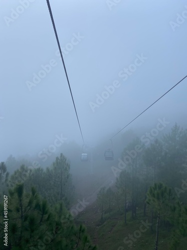 foggy chairlift in the mountains