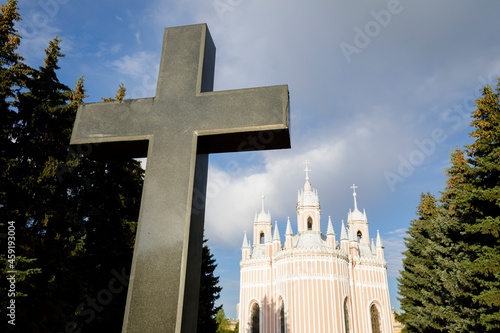 The granite cross and the Church of the Nativity of John the Baptist 