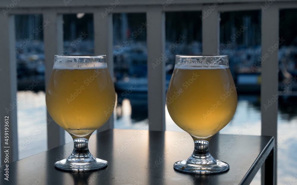 Two glasses of ale served at balcony facing Port Ludlow moorage Two glasses of ale served at balcony facing Port Ludlow moorage