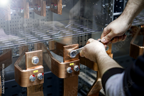 electrical technician tightening copper busbars