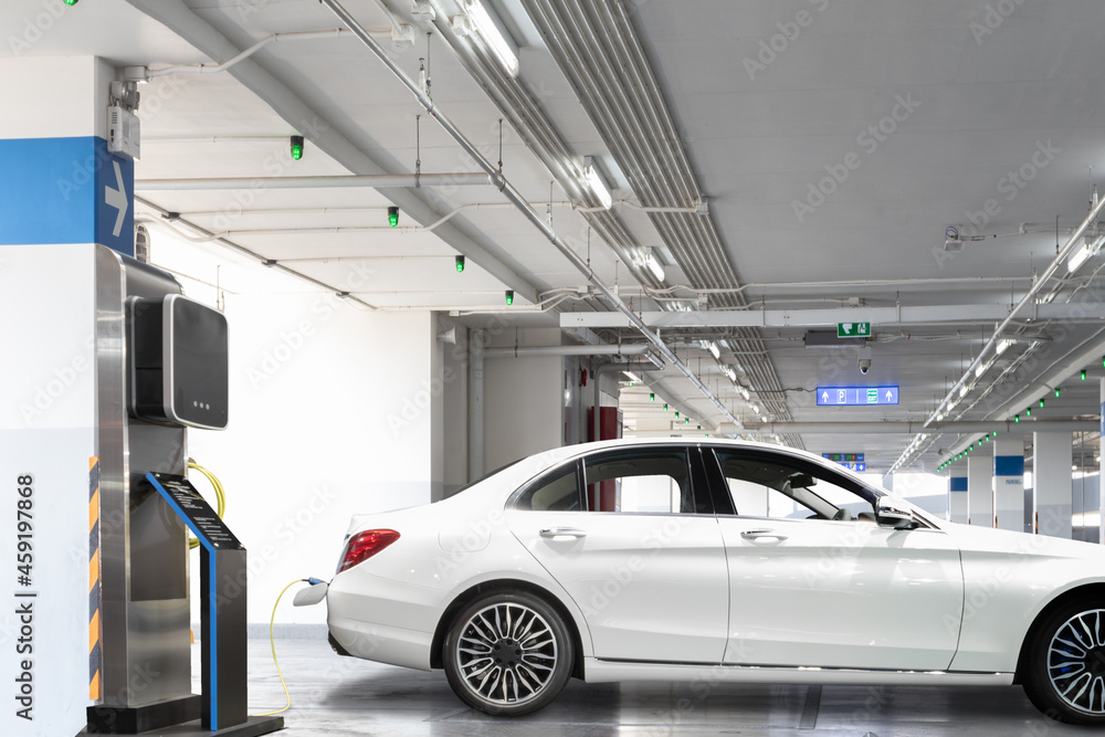 Charging an electric car at modern station parking for clean energy in the future of transportation ecology concept