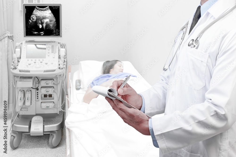 Doctor recording check health obstetric ultrasound of fetus by ultrasonic scan for diagnose the condition of a pregnant woman on the computer screen Doctor recording check health obstetric ultrasound of fetus by ultrasonic scan for diagnose the condition of a pregnant woman on the computer screen