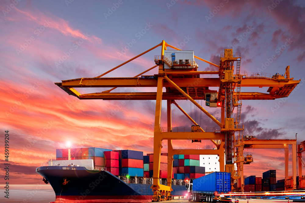Crane bridge in cargo port during container loading in a cargo freight ship in sunset. Import and export logistic and transportation concept