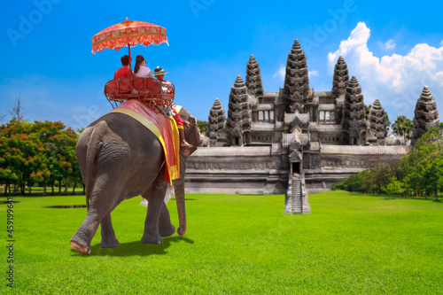 Tourists on and ride elephant tour the ancient city of Angkor wat , Cumbodia. © thanapun