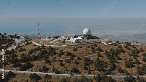 Meteorology science station in highland mountain range. Aerial meteorological scientific observatory. Wild nature countryside landscape. Weather forecasting. Astronomy and climatology. Aerial panorama photo
