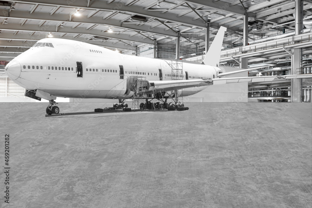 Fototapeta premium Airplane are performing repairs, fixes, modernization and renovation in the aviation hangar