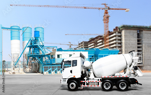Cement delivery truck in concrete plant against construction site