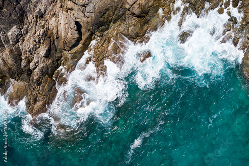 Aerial view Top down seashore wave crashing on seashore Beautiful turquoise sea surface in sunny day Good weather day summer background Amazing seascape top view