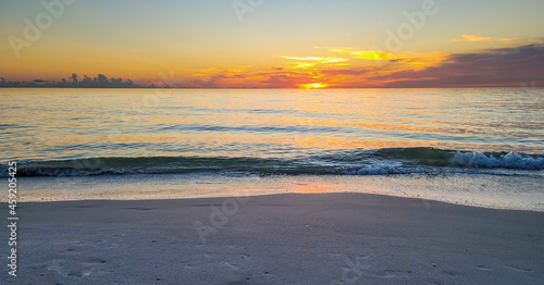 Small waves rolling inshore at sunset in Florida Naples Florida Beaches