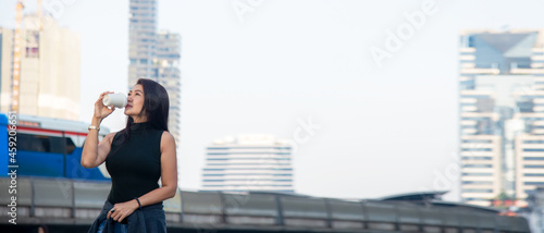 Asia people tourist women sightseeing city with drinking coffee. Lifestyle traveler walking at Bangkok urban, Thailand. Lifestyle and Travel Concept, copy space for banner