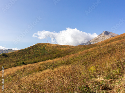 Panoramic views of the mountains from hiking trails in the mountainous area on a warm, sunny autumn day, walking and communicating with nature.