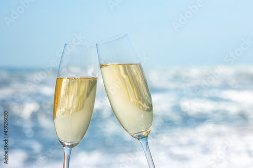 two glasses of champagne on the sea beach