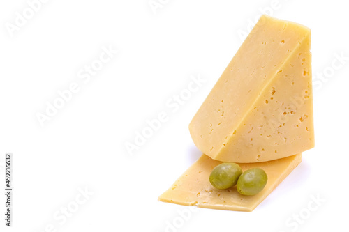 A piece of hard yellow gouda cheese with olives close-up, isolated on a white background.selective focus