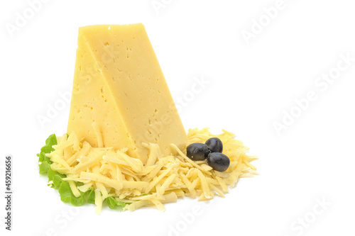 A piece of hard yellow cheese with olives in close-up, isolated on a white background.selective focus