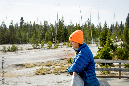 Adventurous Girl exploring the outdoors with blaze orange hat and vibrant blue jacket. 