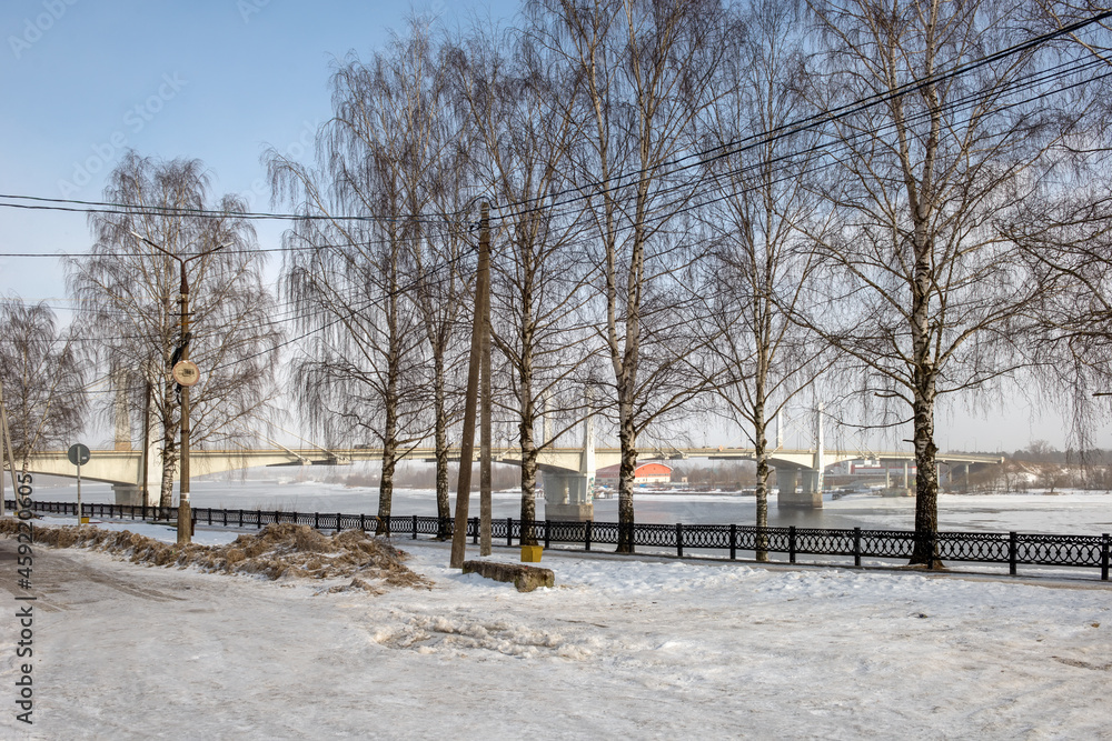 Savelovsky bridge over Volga River in Kimry town, Tver oblast, Russia. View from the Fadeev embankment on a winter day. Architecture, buildings and scenic nature. Landscape of Kimry