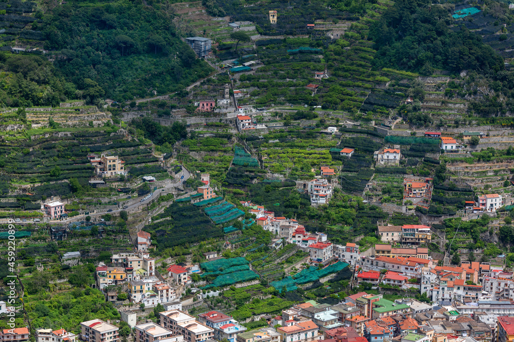 A scenic aerial view of villages, lemon and vine plantations on the Amalfi coast in Italy.