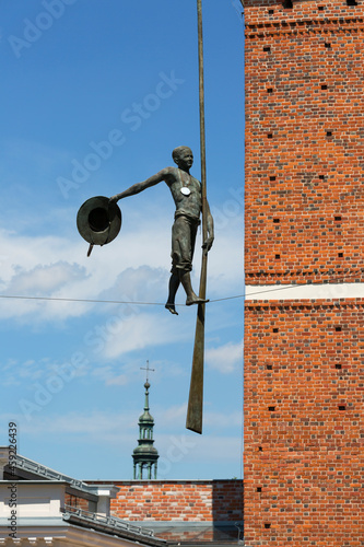 Fotografie 14th century gothic entrance Opatowska Gate, sculpture of a bargeman going down