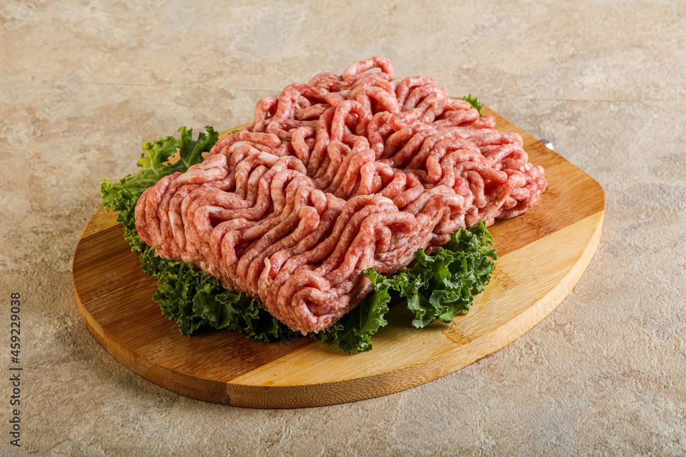Raw pork minced meat over board Raw pork minced meat over board