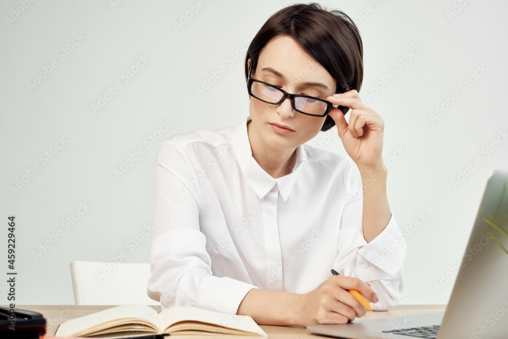 female manager in the office with glasses self-confidence light background female manager in the office with glasses self-confidence light background