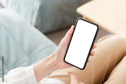 cell phone blank white screen mockup.hand holding texting using mobile on desk at office.background empty space for advertise.work people contact marketing business,technology