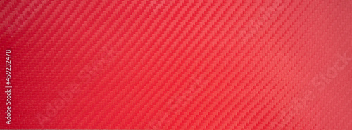 Red carbon fiber texture of rectangular shape. Vinyl carbon film.