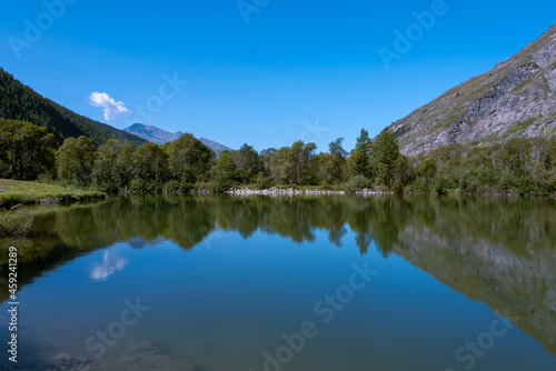 the sky reflecting in the waters of the lake of Bessans in Haute Maurienne in the French Alps © Thierryjdv