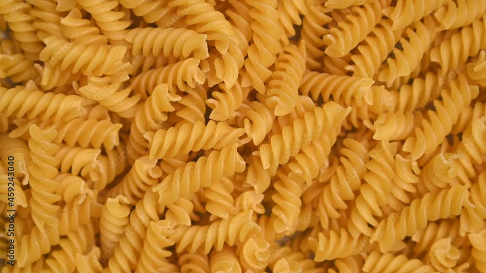 Trendy flat view closeup rolling yellow macaroni. Top view, flat lay. Nature concept. Texture background, pattern. Restaurant work concept. Ready for use, copy space Trendy flat view closeup rolling yellow macaroni. Top view, flat lay. Nature concept. Texture background, pattern. Restaurant work concept. Ready for use, copy space