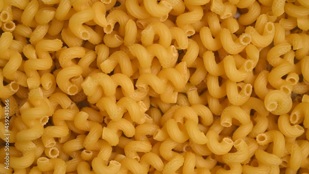 Trendy flat view closeup rolling yellow macaroni. Top view, flat lay. Nature concept. Texture background, pattern. Restaurant work concept. Ready for use, copy space Trendy flat view closeup rolling yellow macaroni. Top view, flat lay. Nature concept. Texture background, pattern. Restaurant work concept. Ready for use, copy space