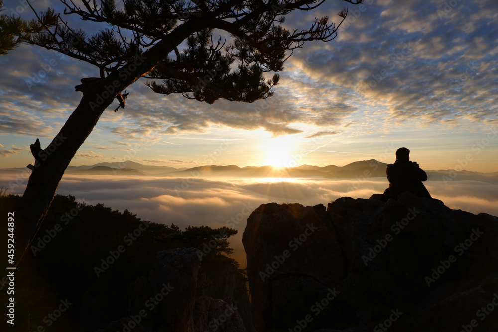 Calm sunset in the mountains with man silhouette