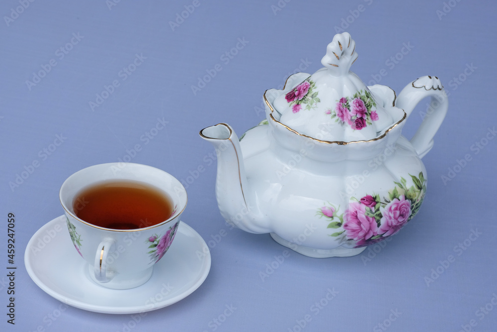 white flower teapot and hot cup and tea white flower teapot and hot cup and tea