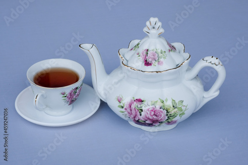 white flower teapot and hot cup and tea